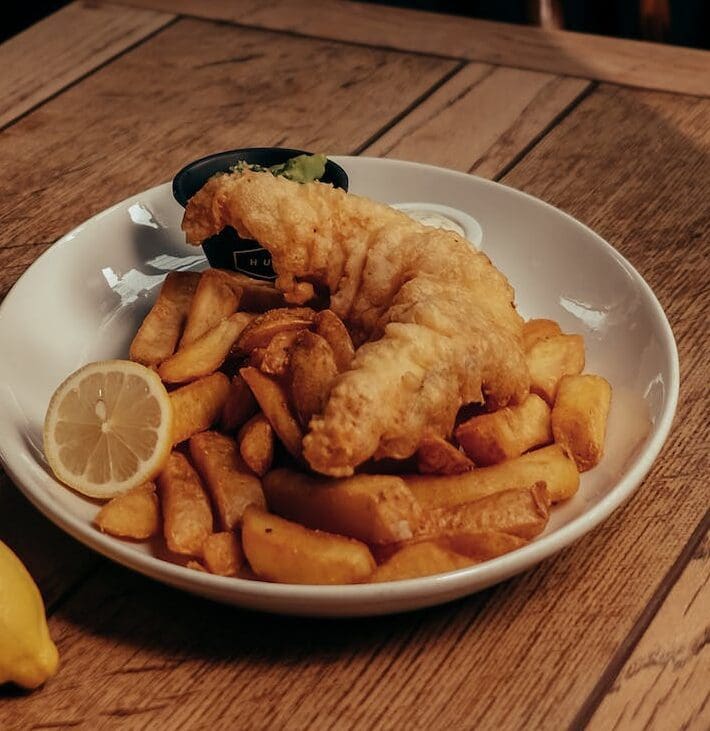 fish potato chips and lemon slice on plate