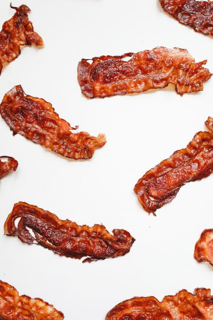 Pre-Cooked Bacon slices on a white background