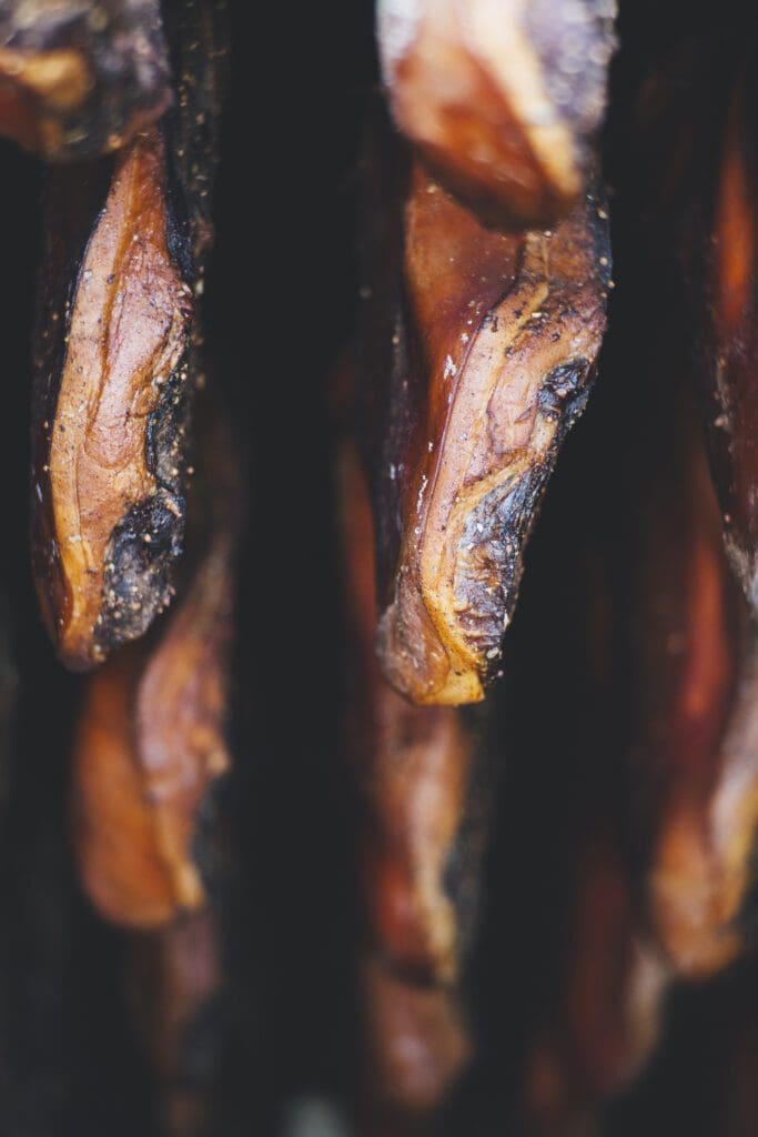 Smoked Meats hanging in a smoker
