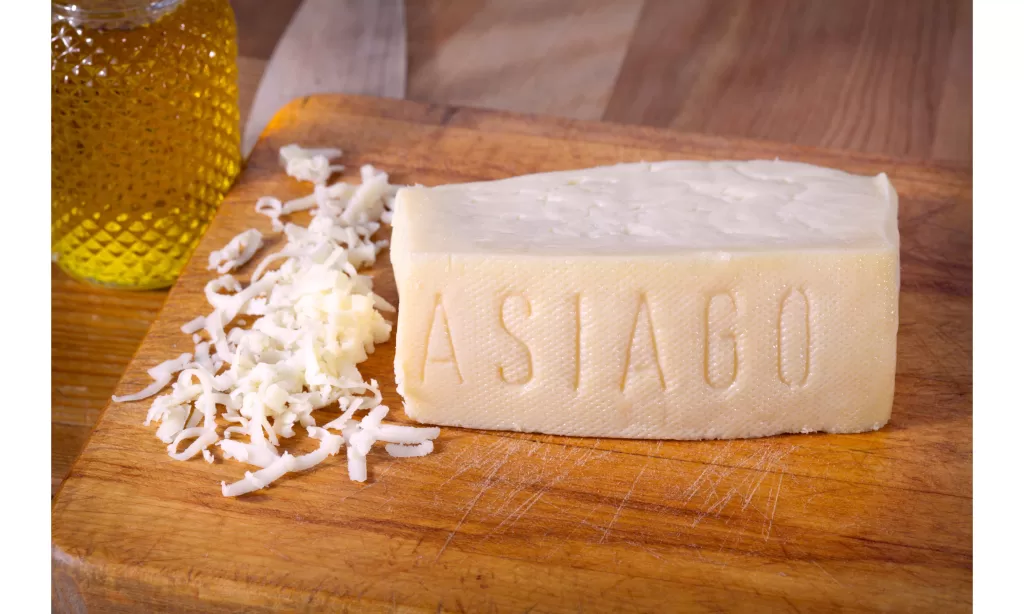 A block of white asiago cheese